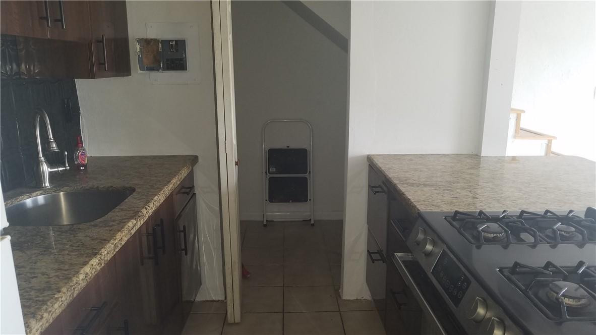 1300 West 53rd Street, Unit 7 Hialeah, FL 33012 - Photo 2 of 22 a kitchen with a sink stove and refrigerator