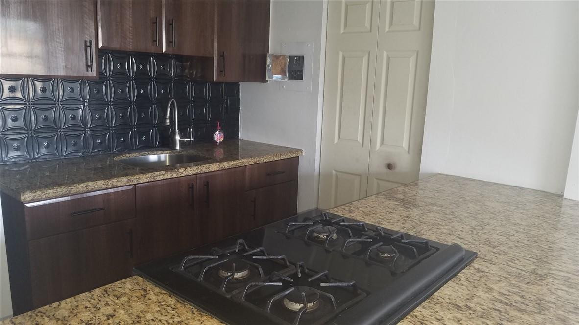 1300 West 53rd Street, Unit 7 Hialeah, FL 33012 - Photo 4 of 22 a kitchen with a sink and a stove