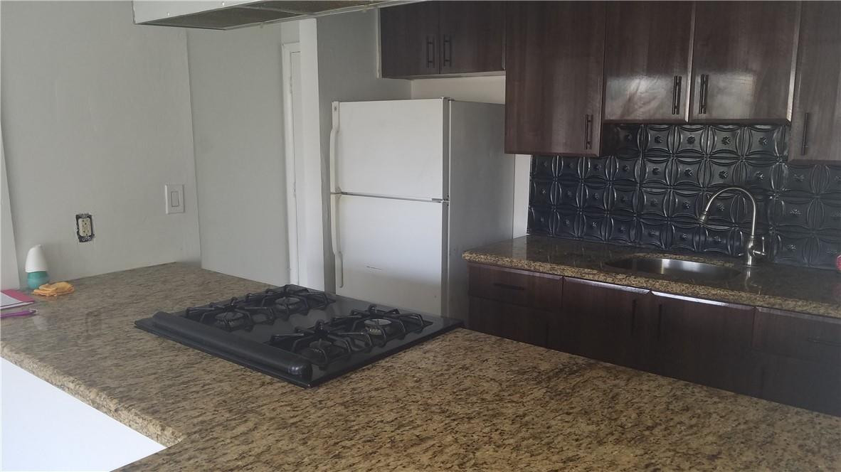 1300 West 53rd Street, Unit 7 Hialeah, FL 33012 - Photo 6 of 22 a kitchen with a refrigerator and a sink