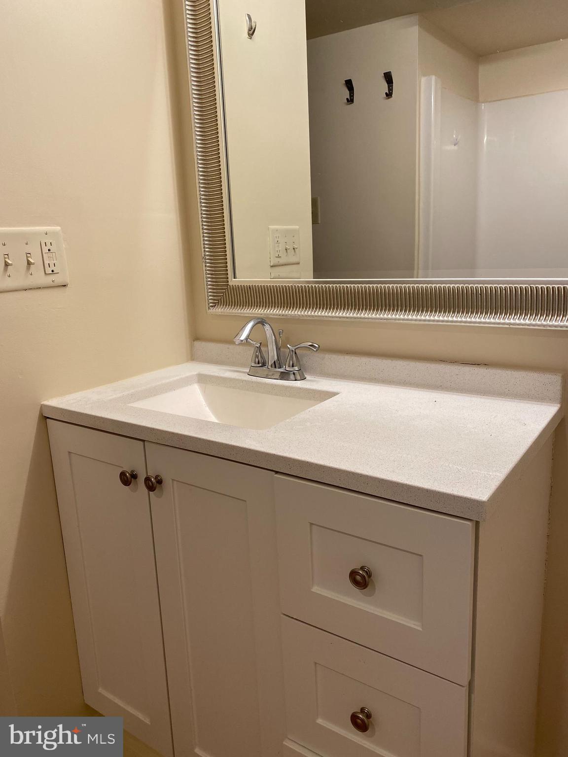 21 North 3rd Street, Unit 4C Philadelphia, PA 19106 - Photo 14 of 14 a bathroom with a sink and a mirror