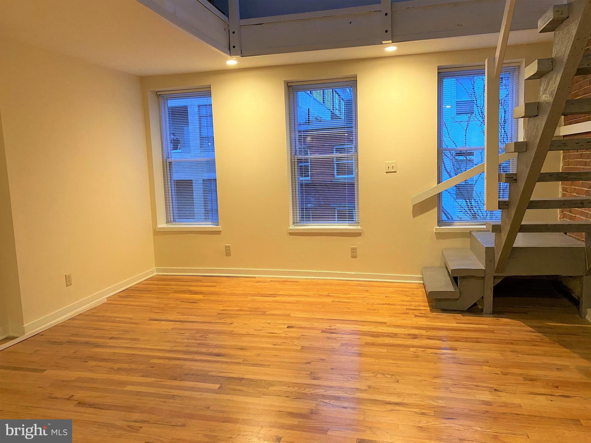 21 North 3rd Street, Unit 4C Philadelphia, PA 19106 - Photo 5 of 14 a view of an empty room with wooden floor and a window