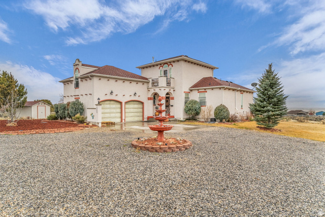 2885 West Ridgeline Road Stockton, UT 84071 - Photo 1 of 1 Mediterranean / spanish home featuring driveway, stucco siding, and an attached garage