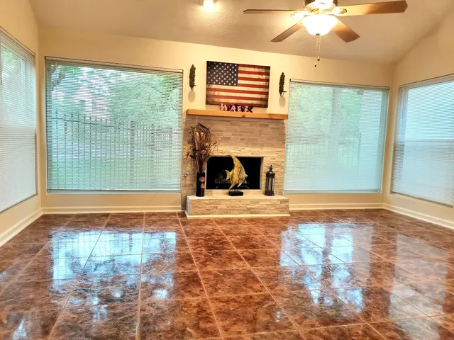 a view of a fireplace and window in the room