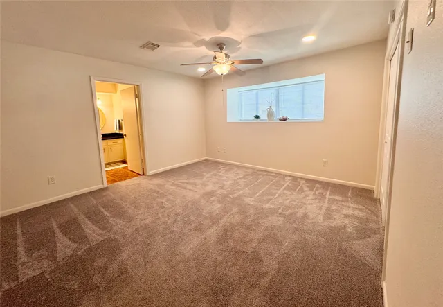 a view of a livingroom with a ceiling fan and window