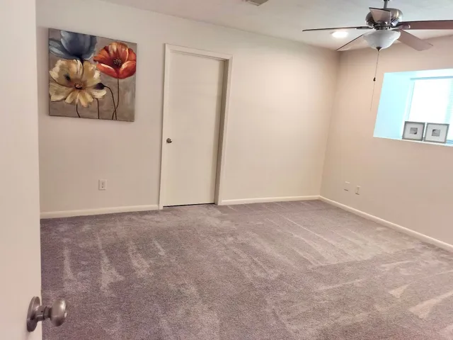 an empty room with a painting on the wall