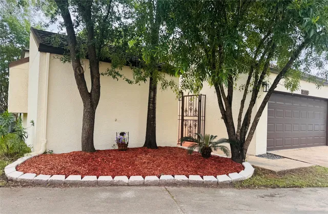 a backyard of a house with table and chairs