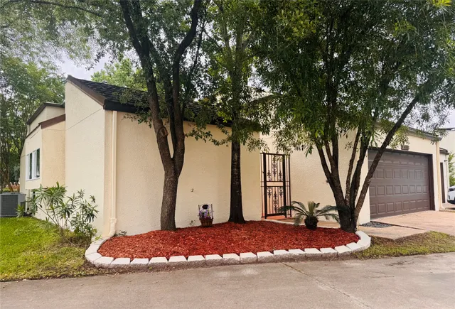 a wooden house with tree in front of it
