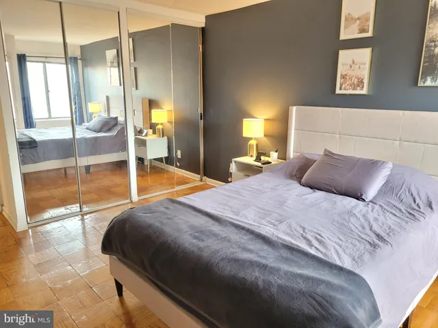 a bedroom with a bed and a lamp next to a window