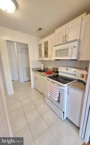 a kitchen with cabinets a sink and appliances