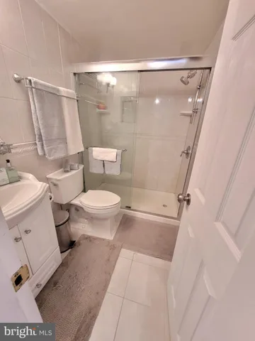 a bathroom with a toilet and a shower