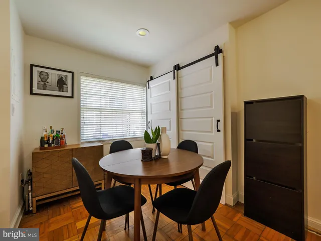 a dining room with furniture and window