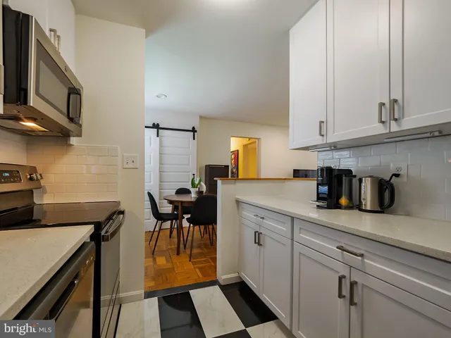 a kitchen with a sink a stove and cabinets