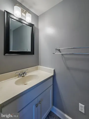 a bathroom with a sink vanity and mirror