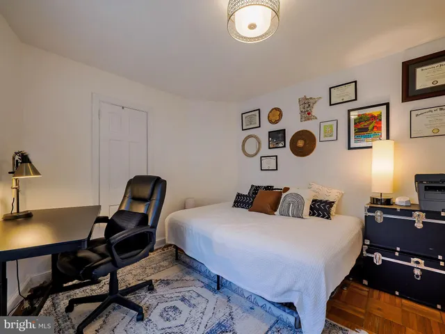 a bedroom with bed and a chair