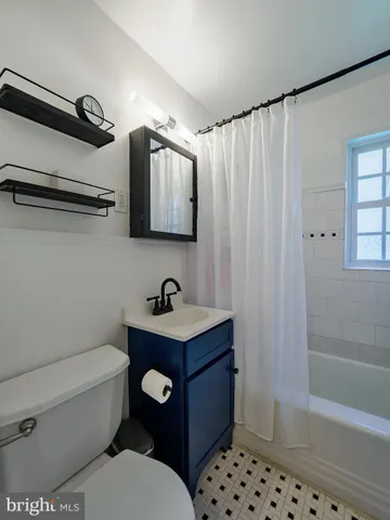 a bathroom with a toilet a sink and bathtub