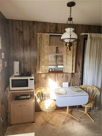 a kitchen with a table chairs and a stove