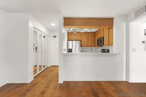 a view of kitchen with wooden floor and a large window