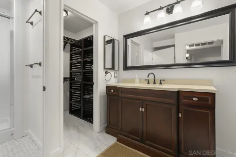 a white toilet next to a bathroom