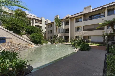 a view of a backyard with plants and lake view