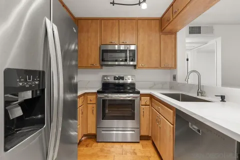 a kitchen with a sink a stove and refrigerator