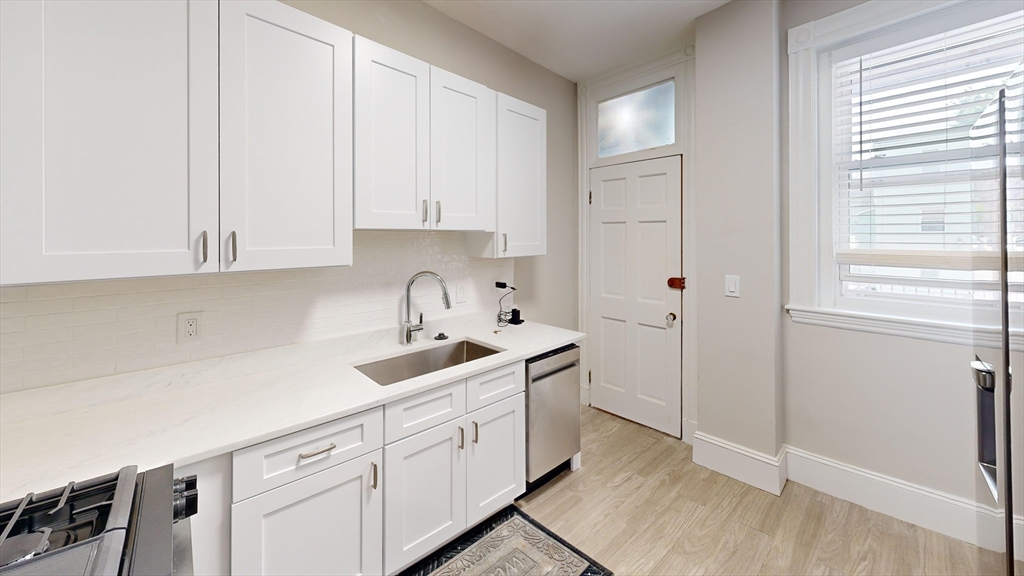 a kitchen with cabinets and window