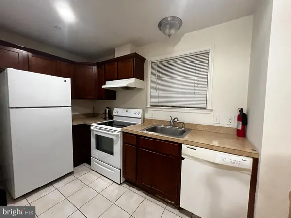 a kitchen with a sink a stove and refrigerator