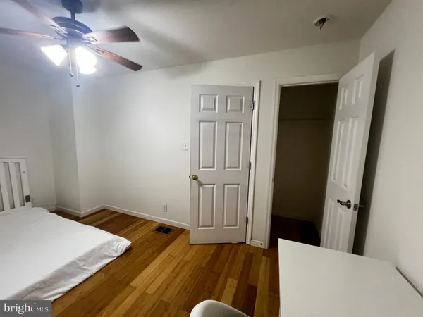 a large bathroom with a toilet sink and mirror