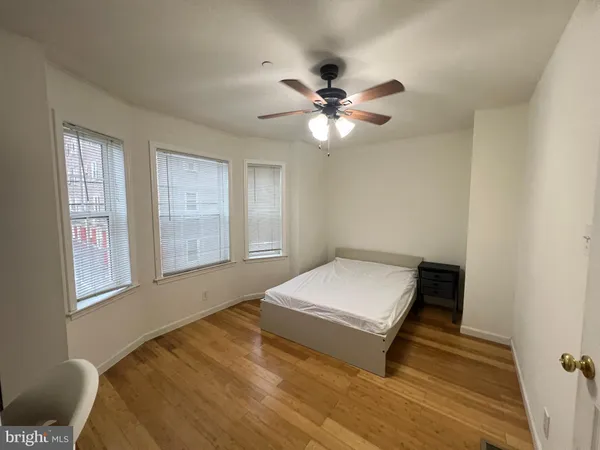 a room with natural light and wooden floor