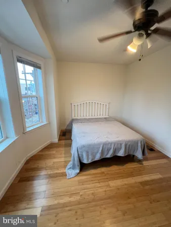 a bed sitting in a bedroom next to a window