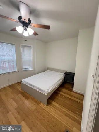 a bedroom with a bed and a ceiling fan