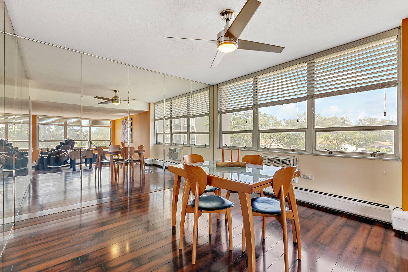 8801 West Golf Road, Unit 3B Niles, IL 60714 - Photo 4 of 17 a dining room with furniture a chandelier and wooden floor