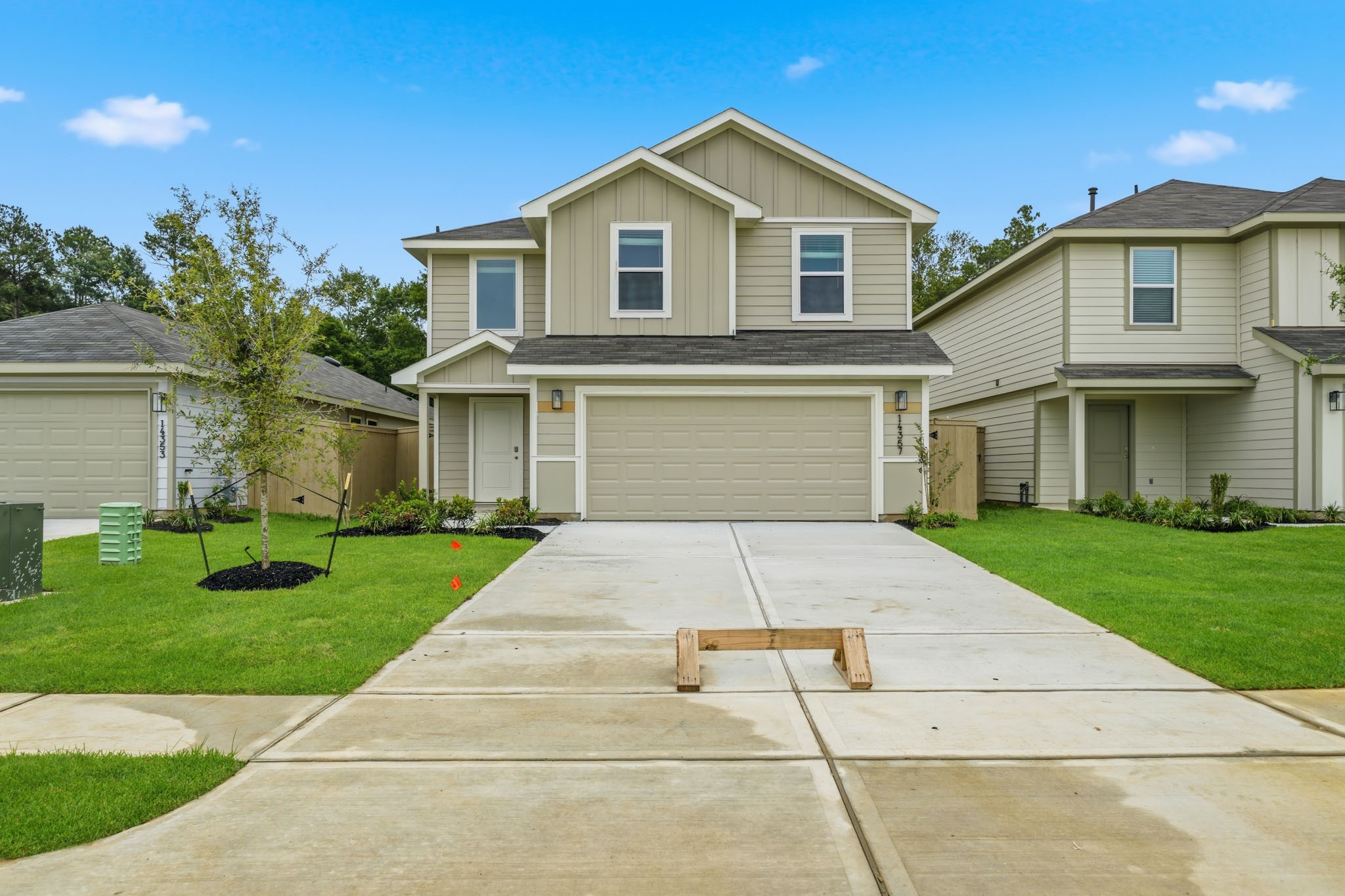 14357 Tawny Street Splendora, TX 77372 - Photo 2 of 28 a front view of a house with a yard and garage