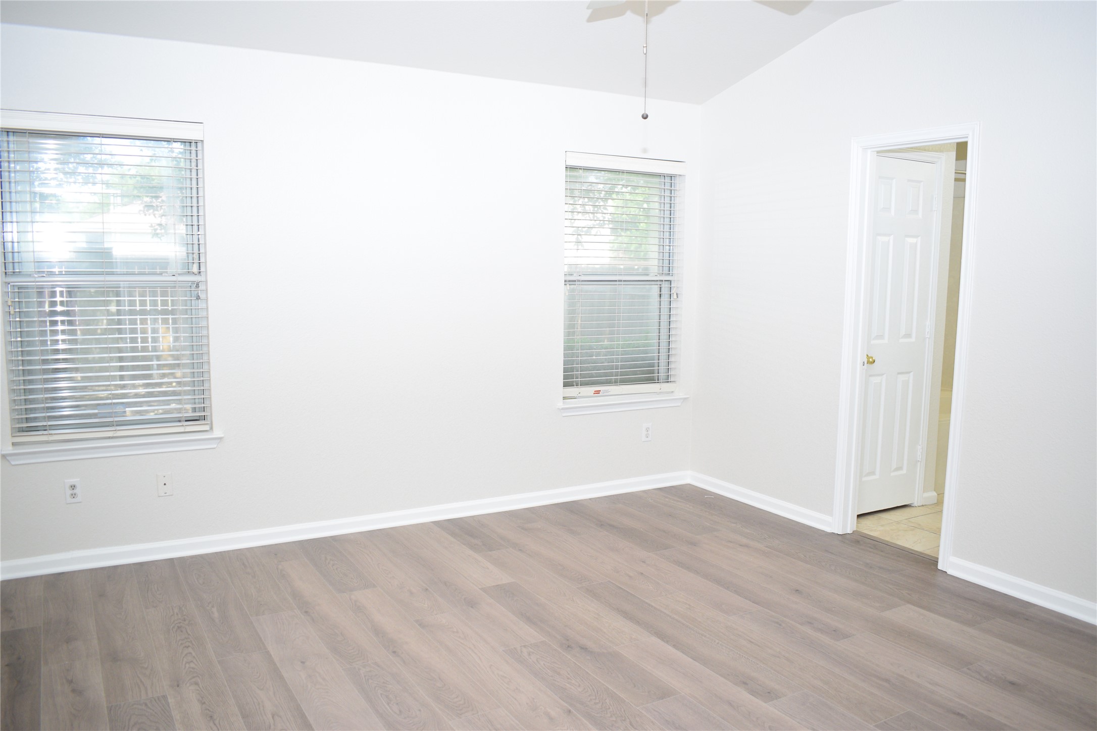 3209 Port Anne Way Leander, TX 78641 - Photo 12 of 30 Spacious room featuring vaulted ceilings, light wood-finish flooring, and white baseboards