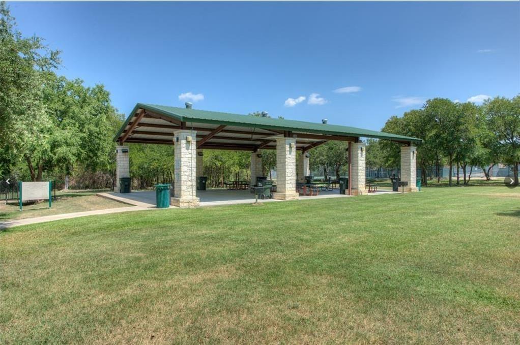 3209 Port Anne Way Leander, TX 78641 - Photo 29 of 30 Spacious covered pavilion featuring stone-clad pillars, a green metal roof, and a concrete slab foundation