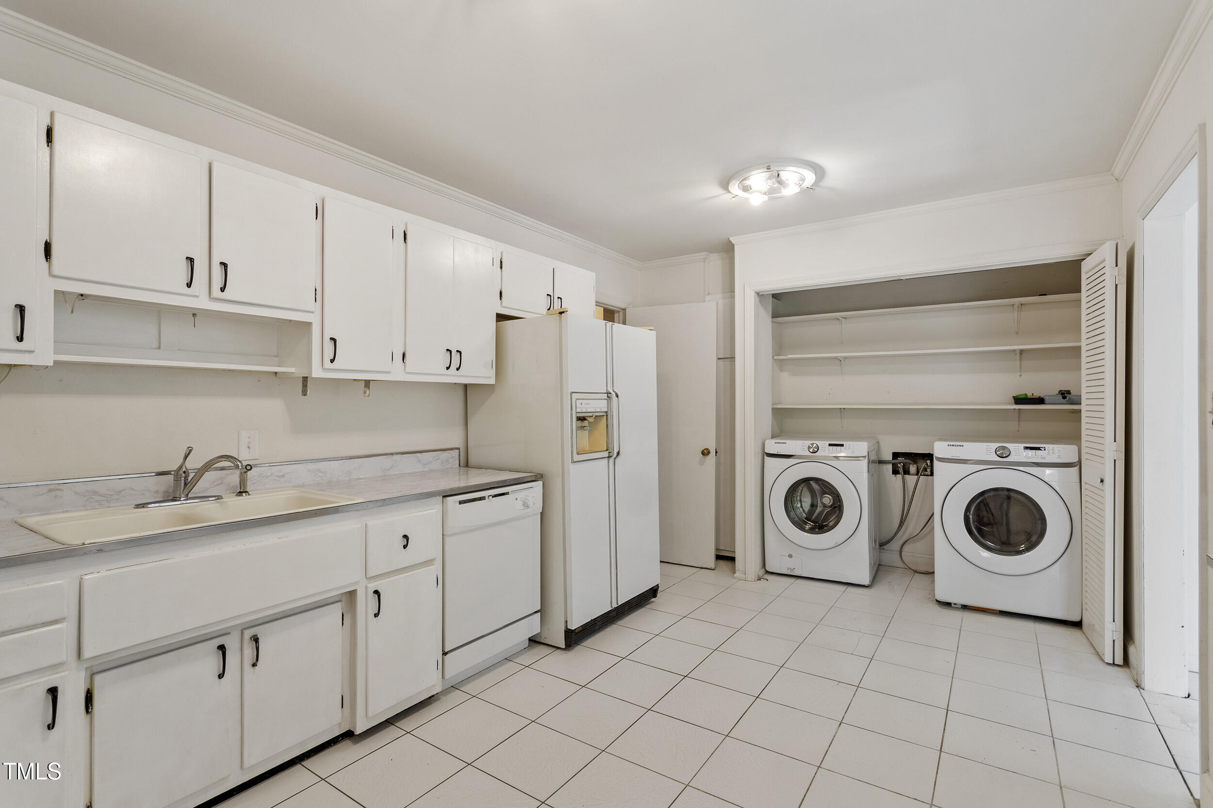 611 Beaver Dam Road Raleigh, NC 27607 - Photo 11 of 36 a utility room with cabinets washer and dryer