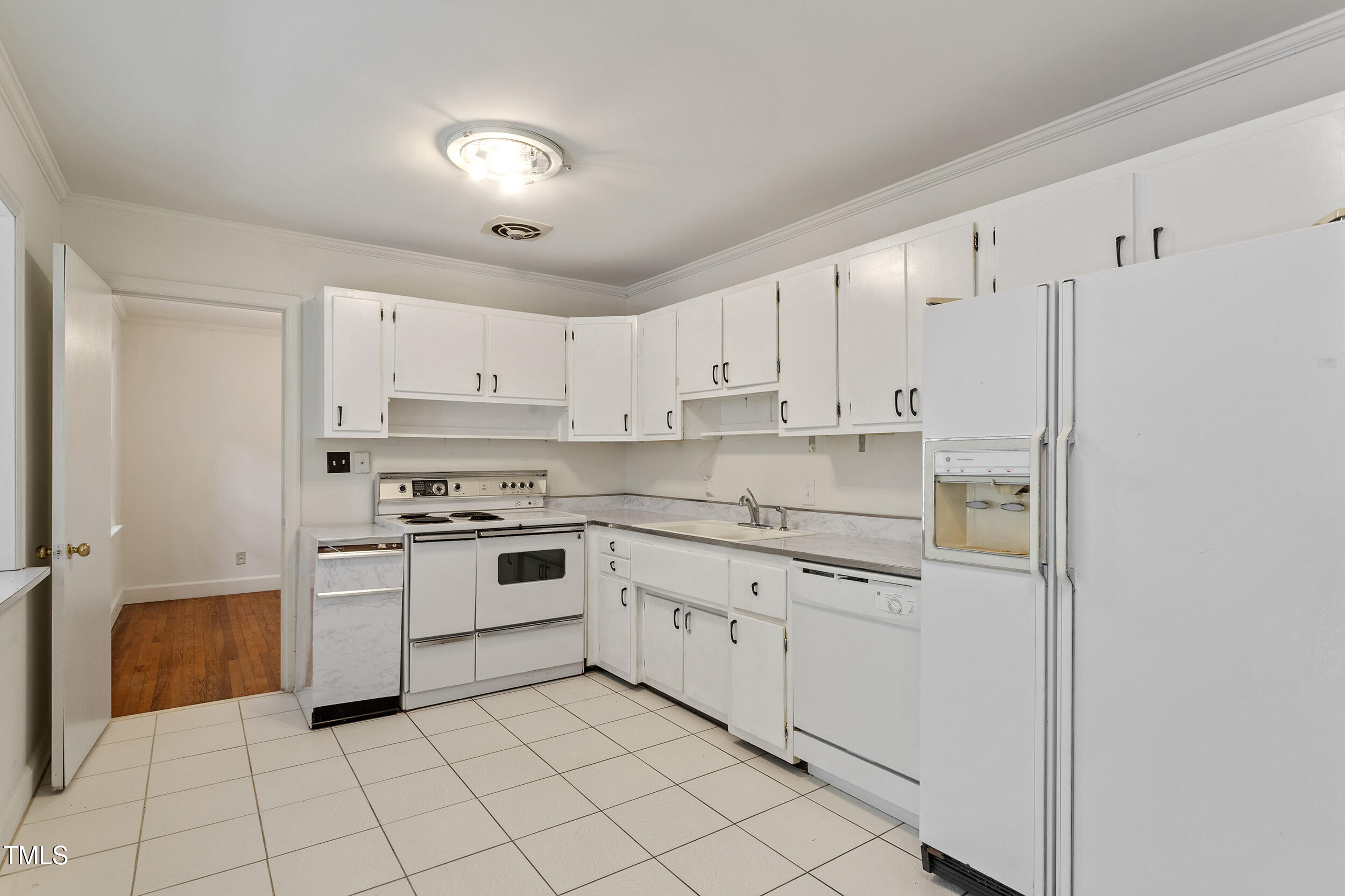 611 Beaver Dam Road Raleigh, NC 27607 - Photo 12 of 36 a kitchen with white cabinets and white appliances