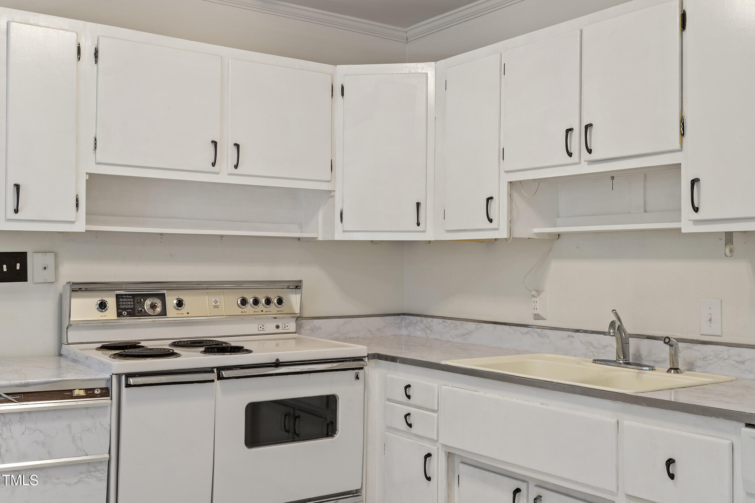 611 Beaver Dam Road Raleigh, NC 27607 - Photo 13 of 36 a kitchen with white cabinets and white appliances