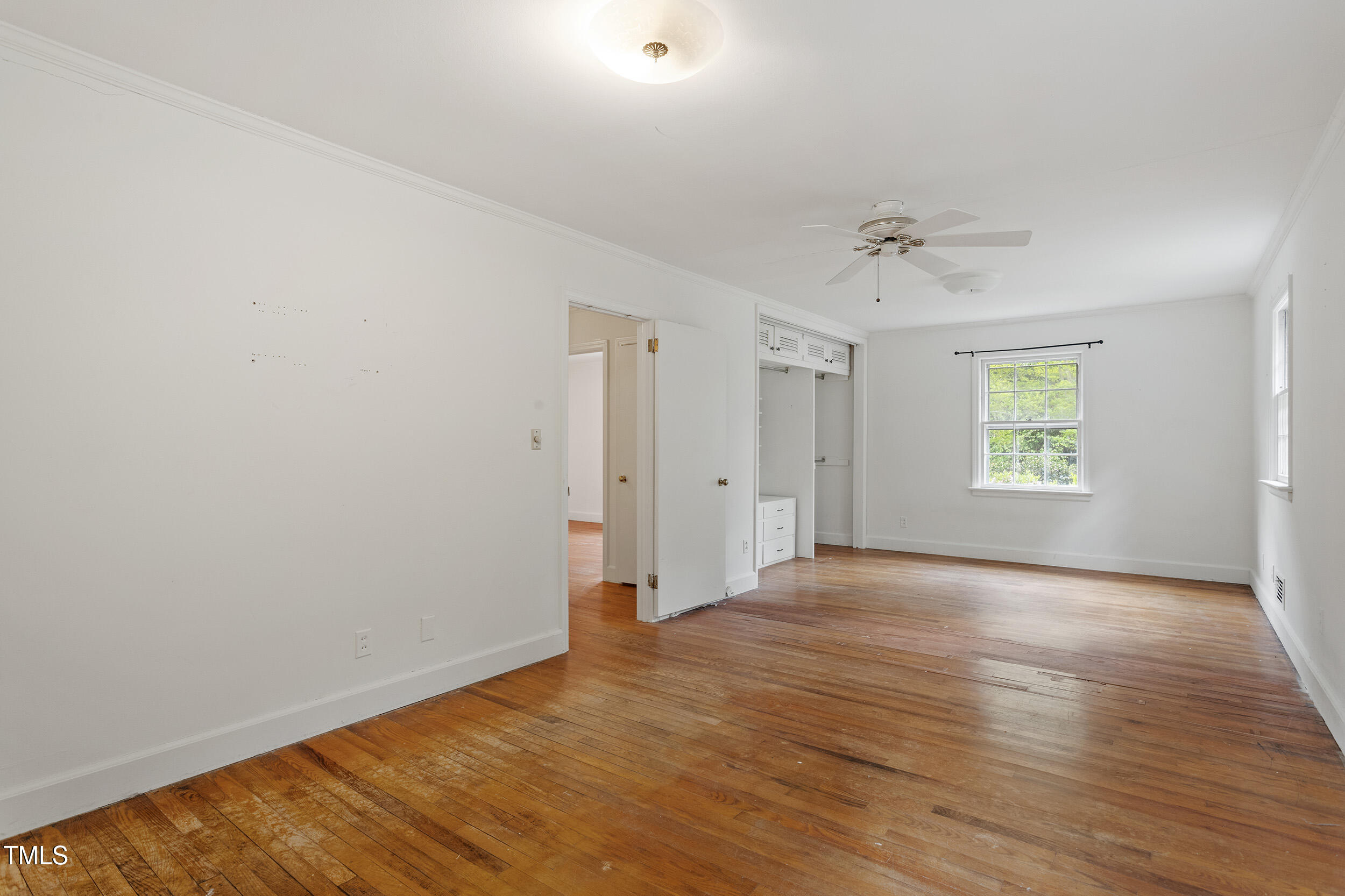 611 Beaver Dam Road Raleigh, NC 27607 - Photo 21 of 36 a view of an empty room with wooden floor and a window