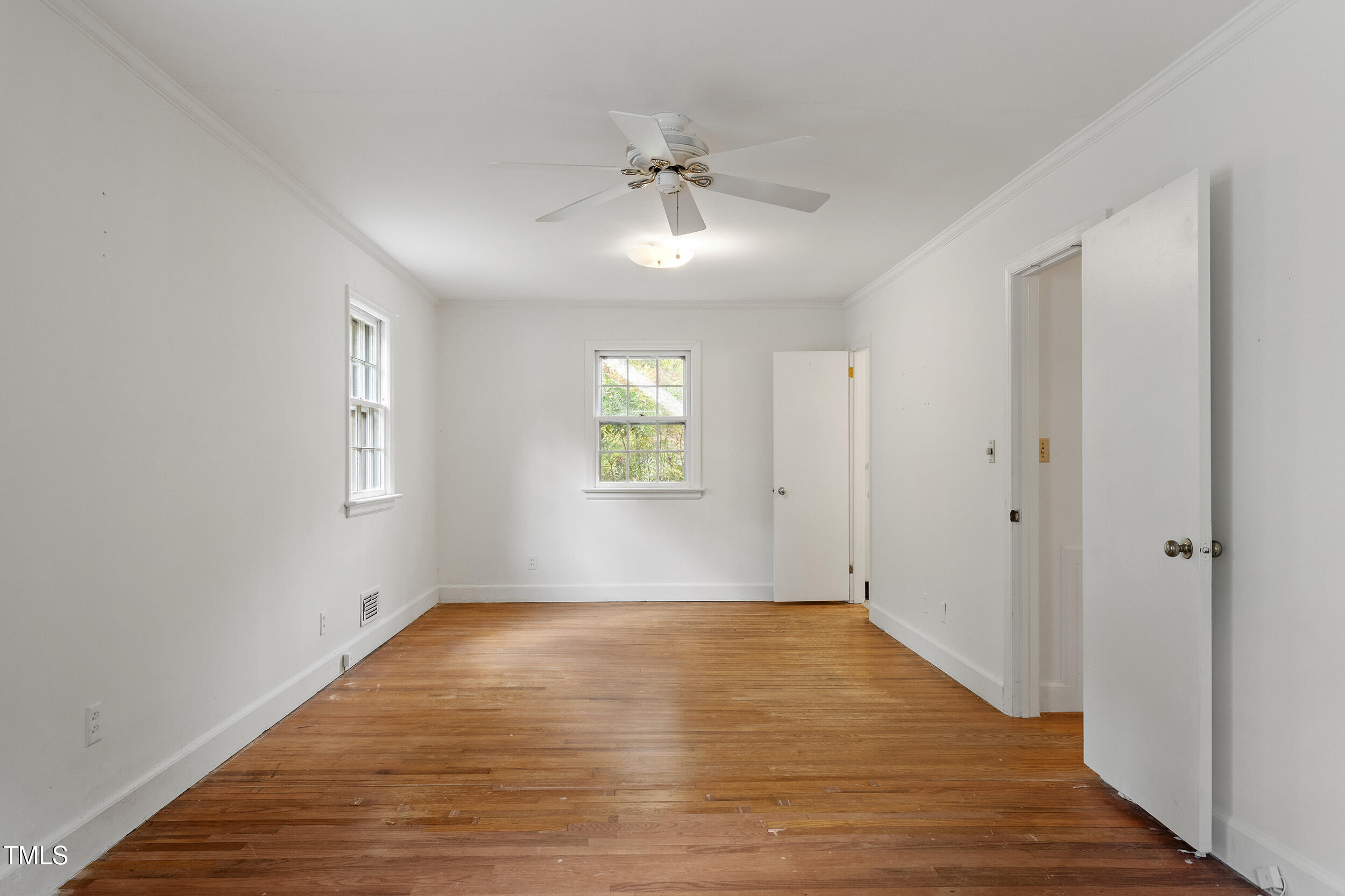 611 Beaver Dam Road Raleigh, NC 27607 - Photo 22 of 36 wooden floor in an empty room with a window