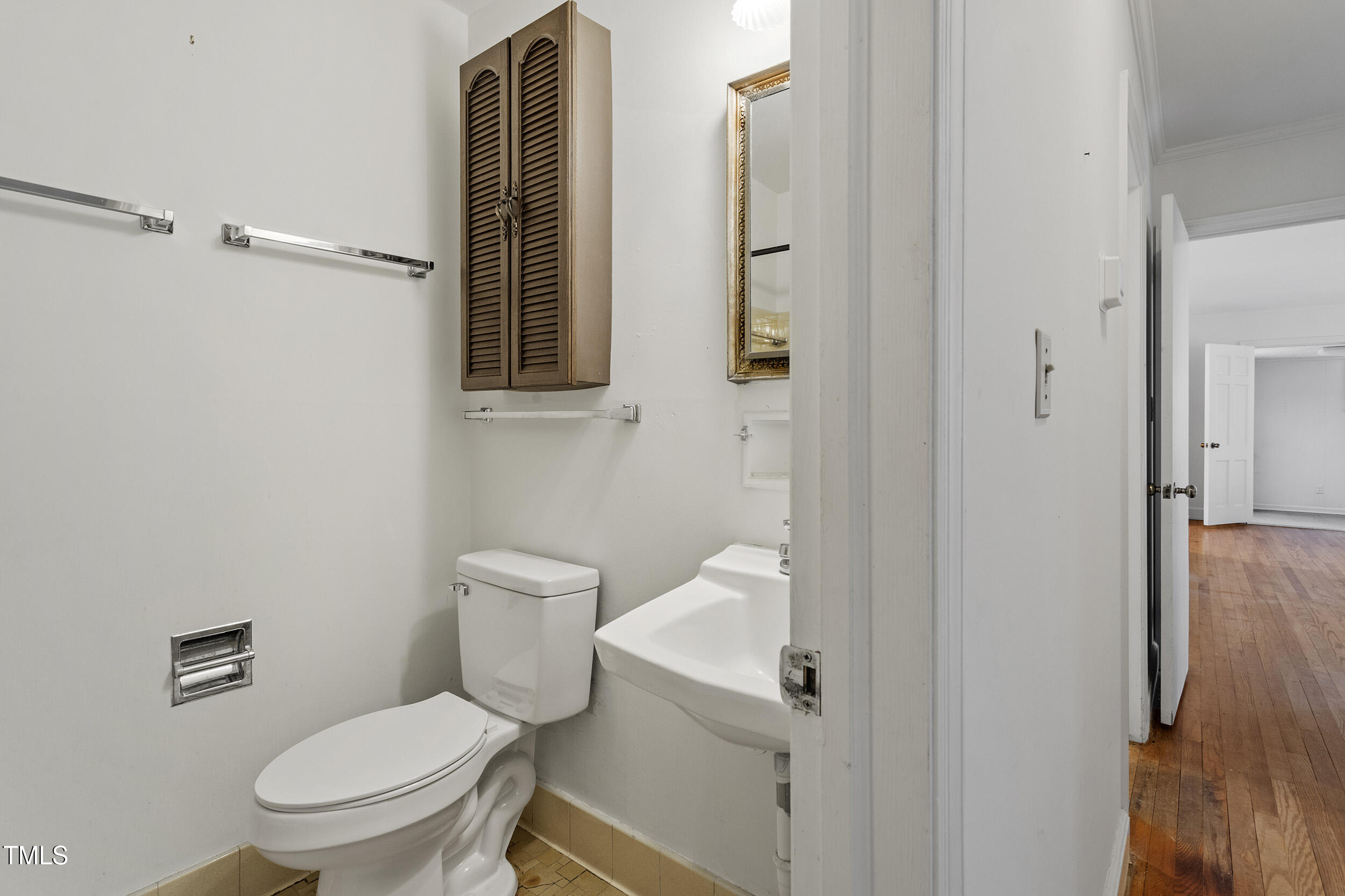 611 Beaver Dam Road Raleigh, NC 27607 - Photo 26 of 36 a white toilet sitting next to a bathroom sink