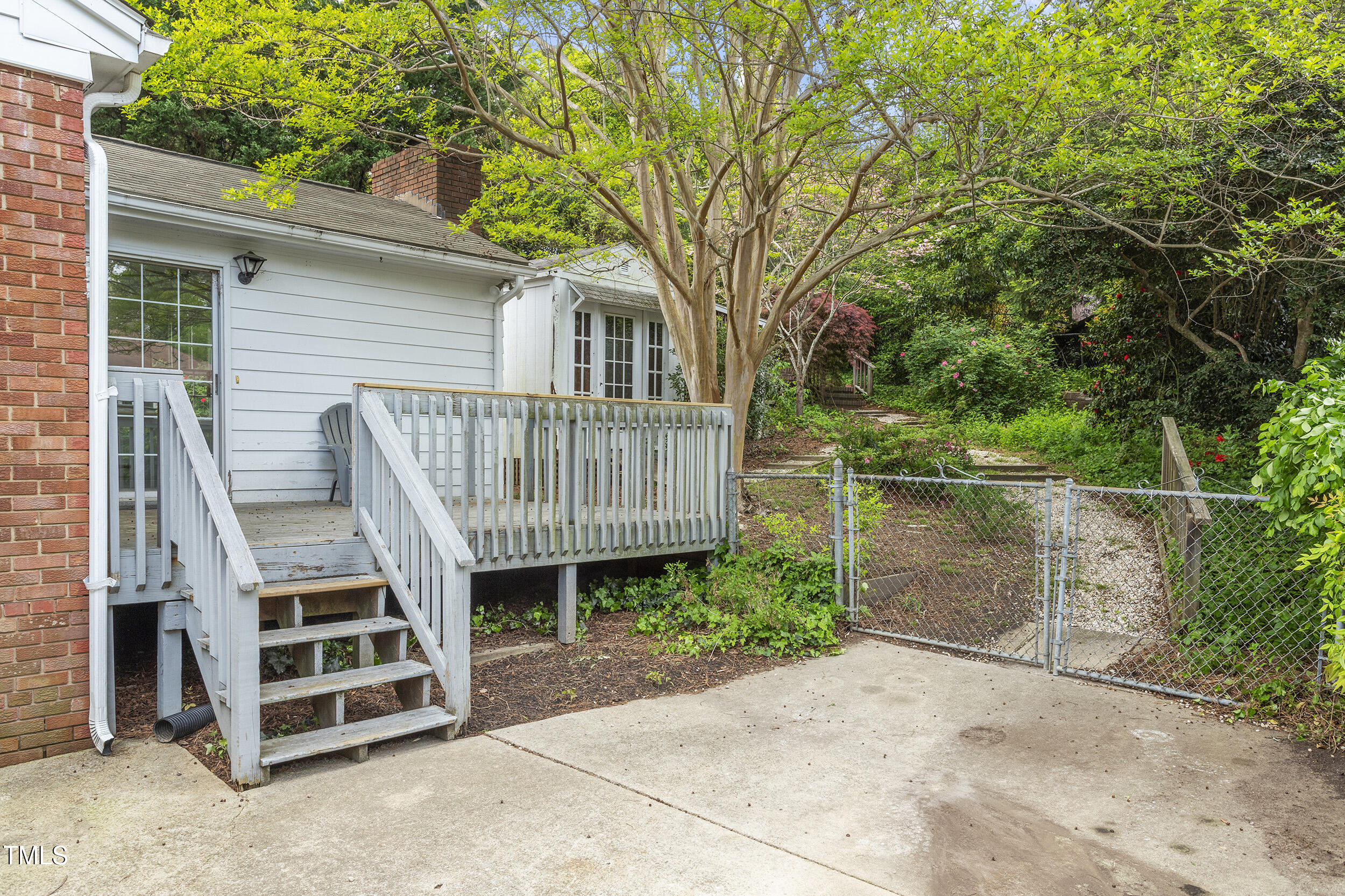 611 Beaver Dam Road Raleigh, NC 27607 - Photo 33 of 36 a view of a wooden deck and a backyard
