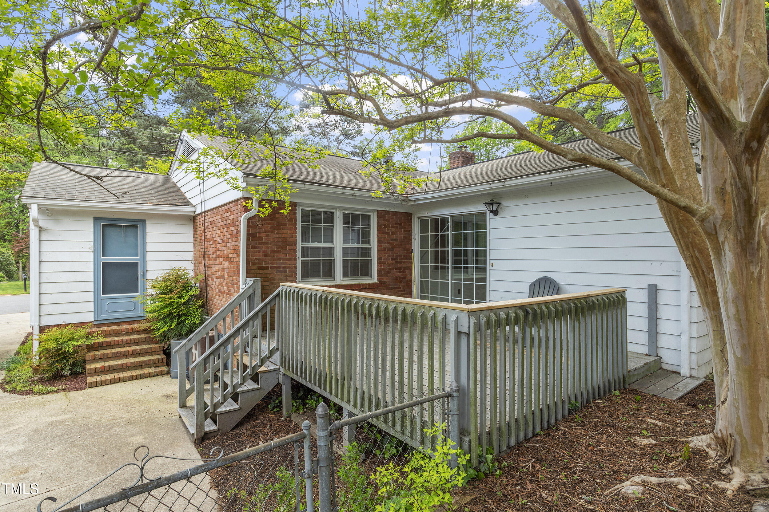 611 Beaver Dam Road Raleigh, NC 27607 - Photo 34 of 36 a view of a house with a small yard and a large tree
