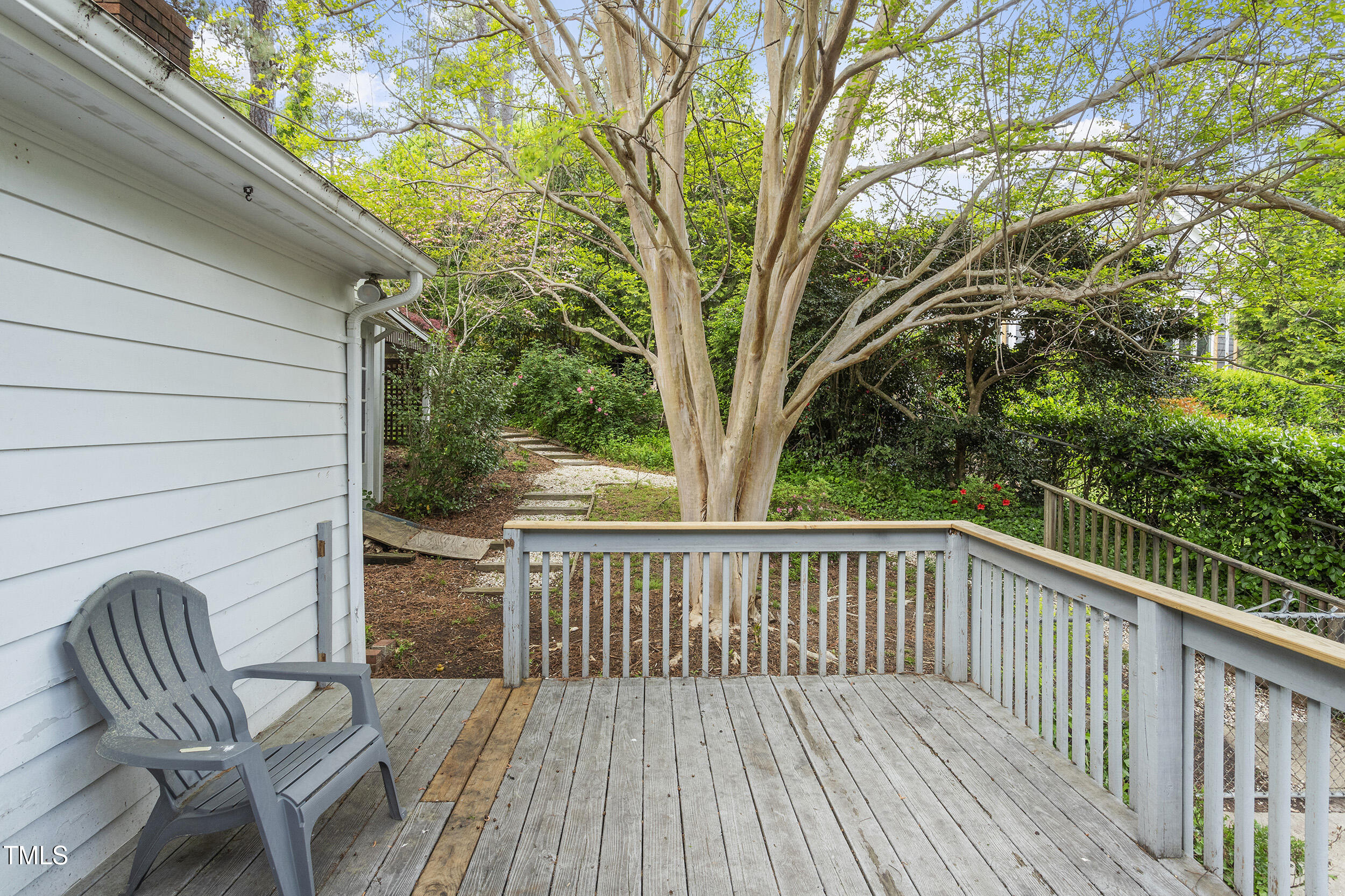 611 Beaver Dam Road Raleigh, NC 27607 - Photo 35 of 36 a balcony with wooden floor and outdoor seating