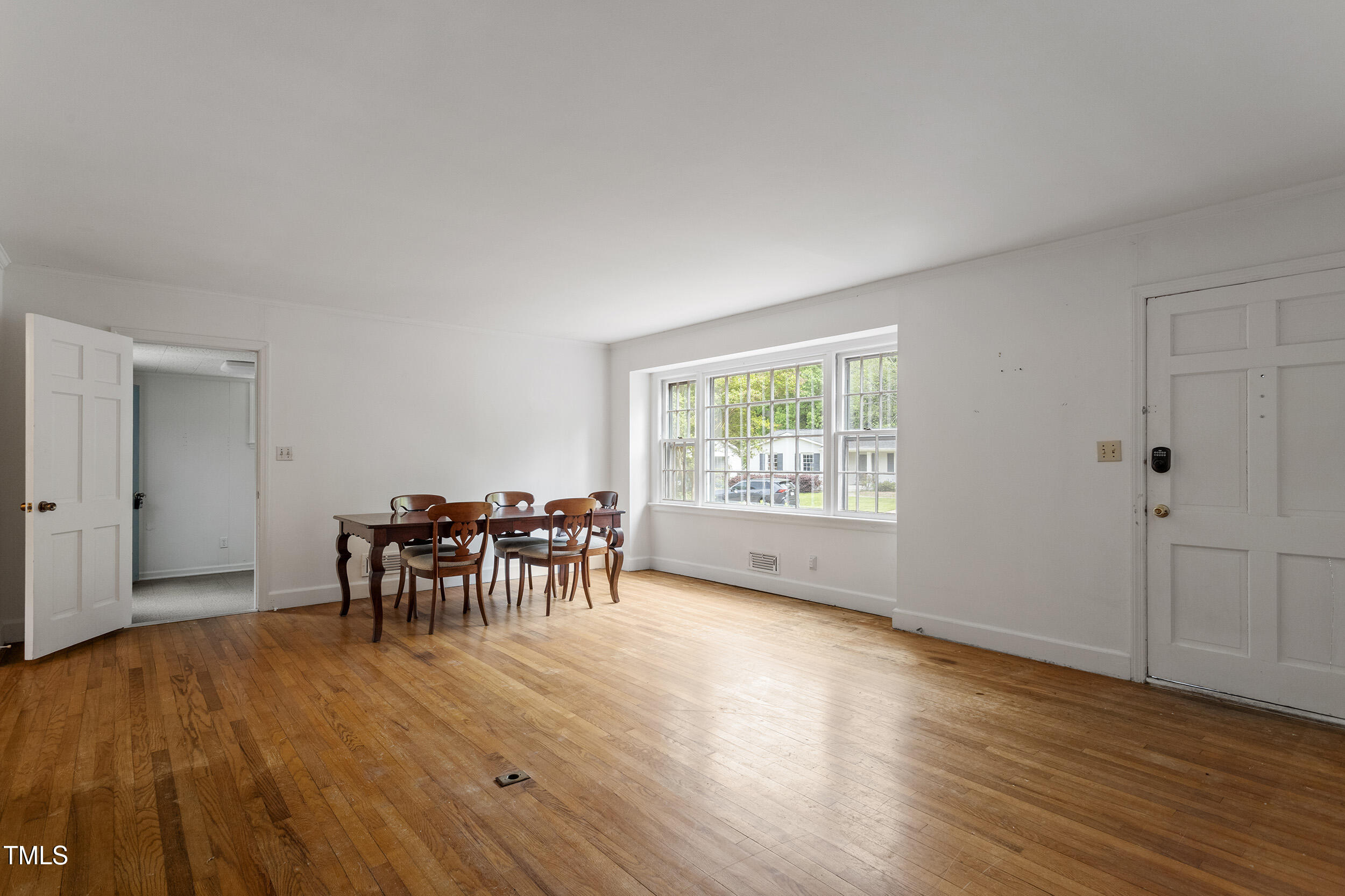 611 Beaver Dam Road Raleigh, NC 27607 - Photo 6 of 36 a view of a work space with wooden floor and a window