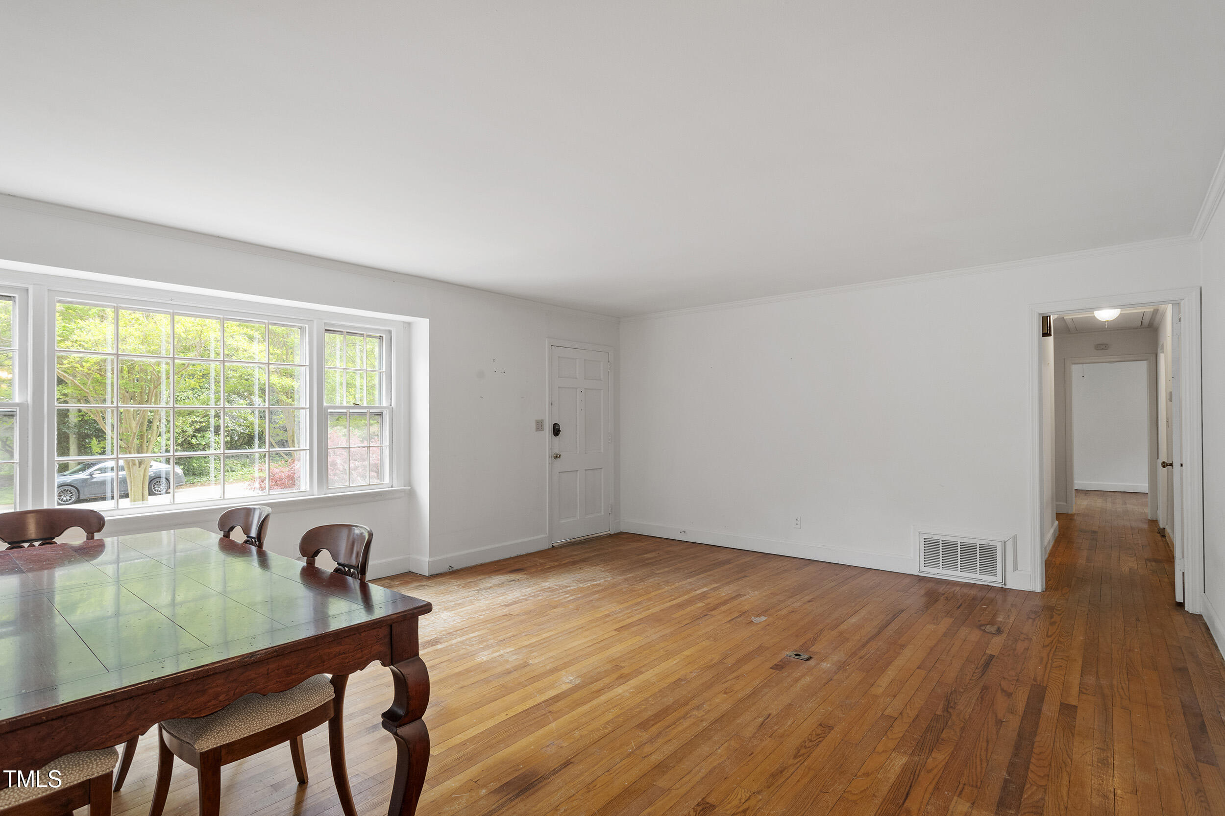 611 Beaver Dam Road Raleigh, NC 27607 - Photo 7 of 36 a view of a livingroom with furniture wooden floor and window