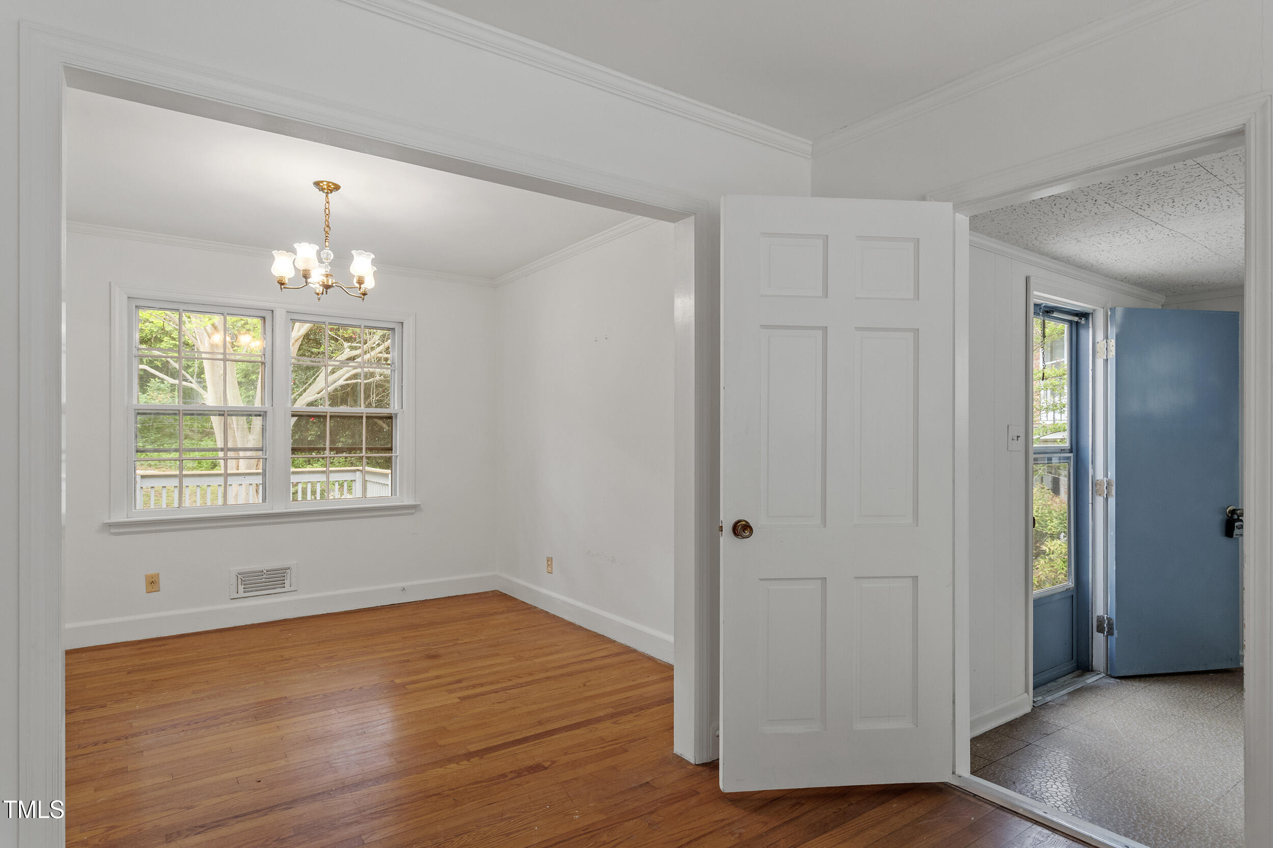 611 Beaver Dam Road Raleigh, NC 27607 - Photo 8 of 36 a view of an empty room with wooden floor and a window