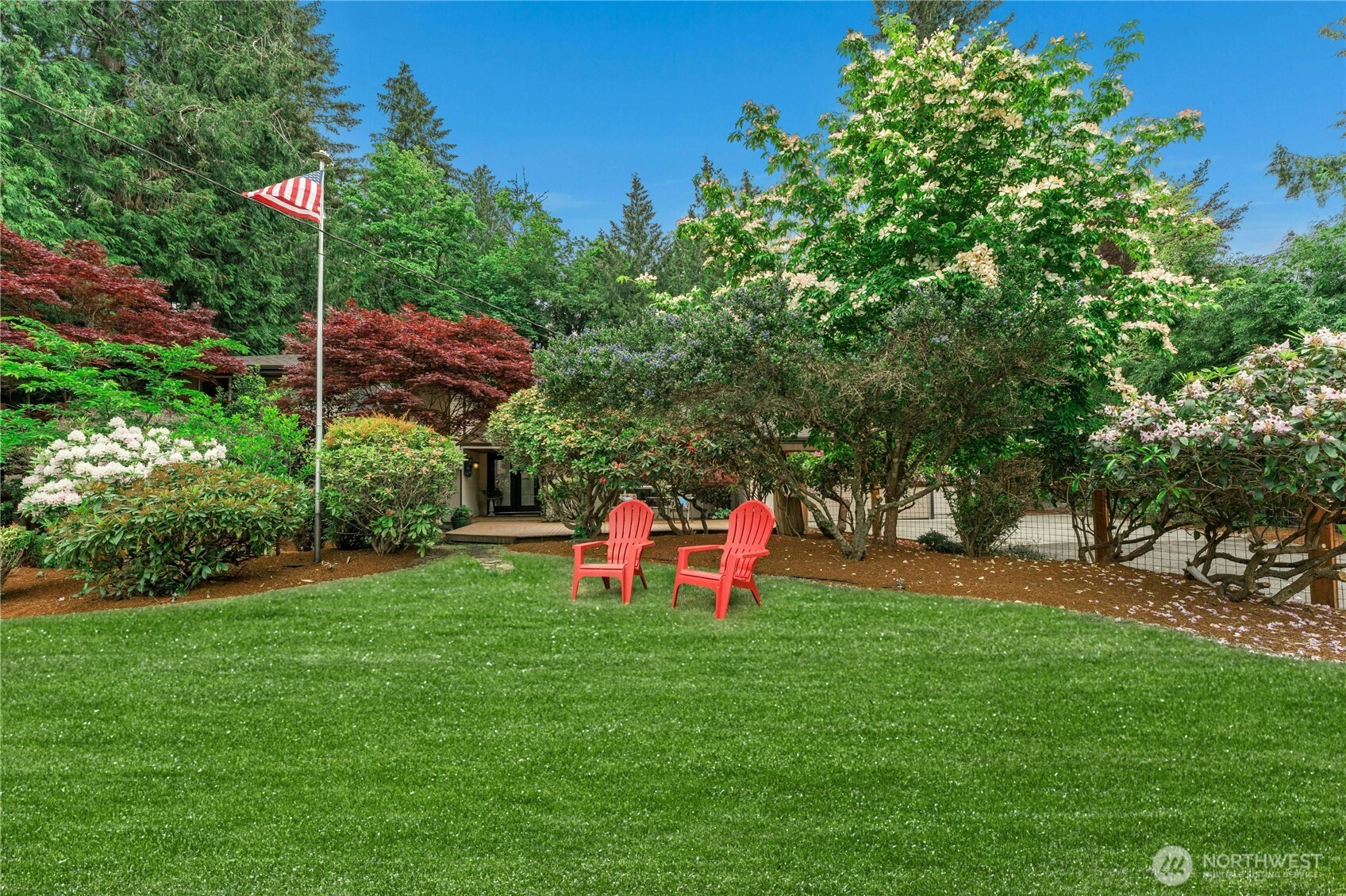 18152 145th Avenue Southeast Renton, WA 98058 - Photo 32 of 40 a view of a park with plants and a bench