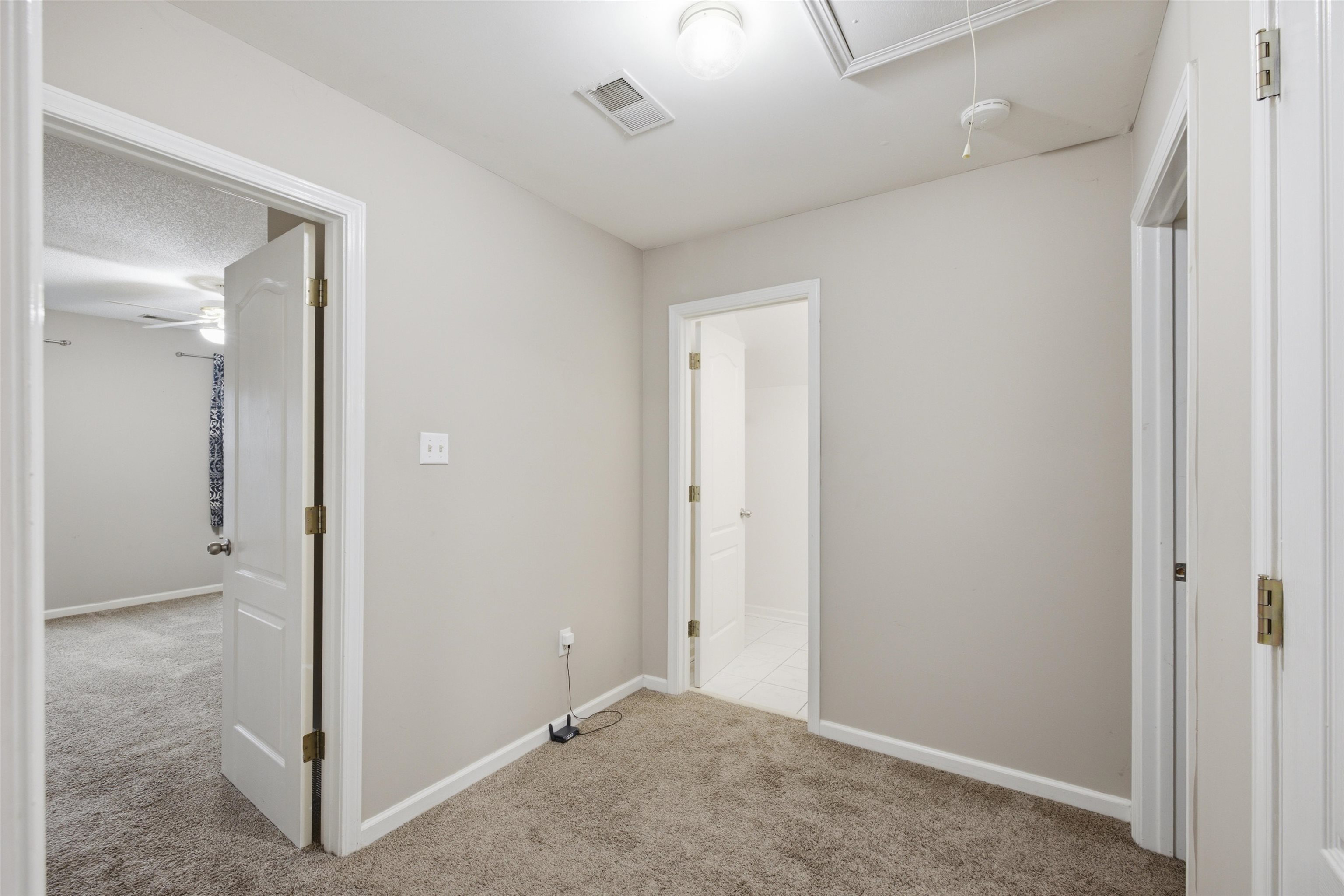 96 Berryfield Cove Collierville, TN 38017 - Photo 23 of 39 Carpeted hallway with light neutral wall tones, white trim, and multiple doorways
