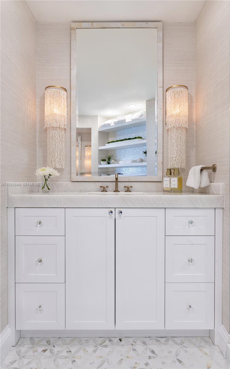 5757 Collins Avenue, Unit 1706 Miami Beach, FL 33140 - Photo 15 of 20 a bathroom with a sink and a mirror