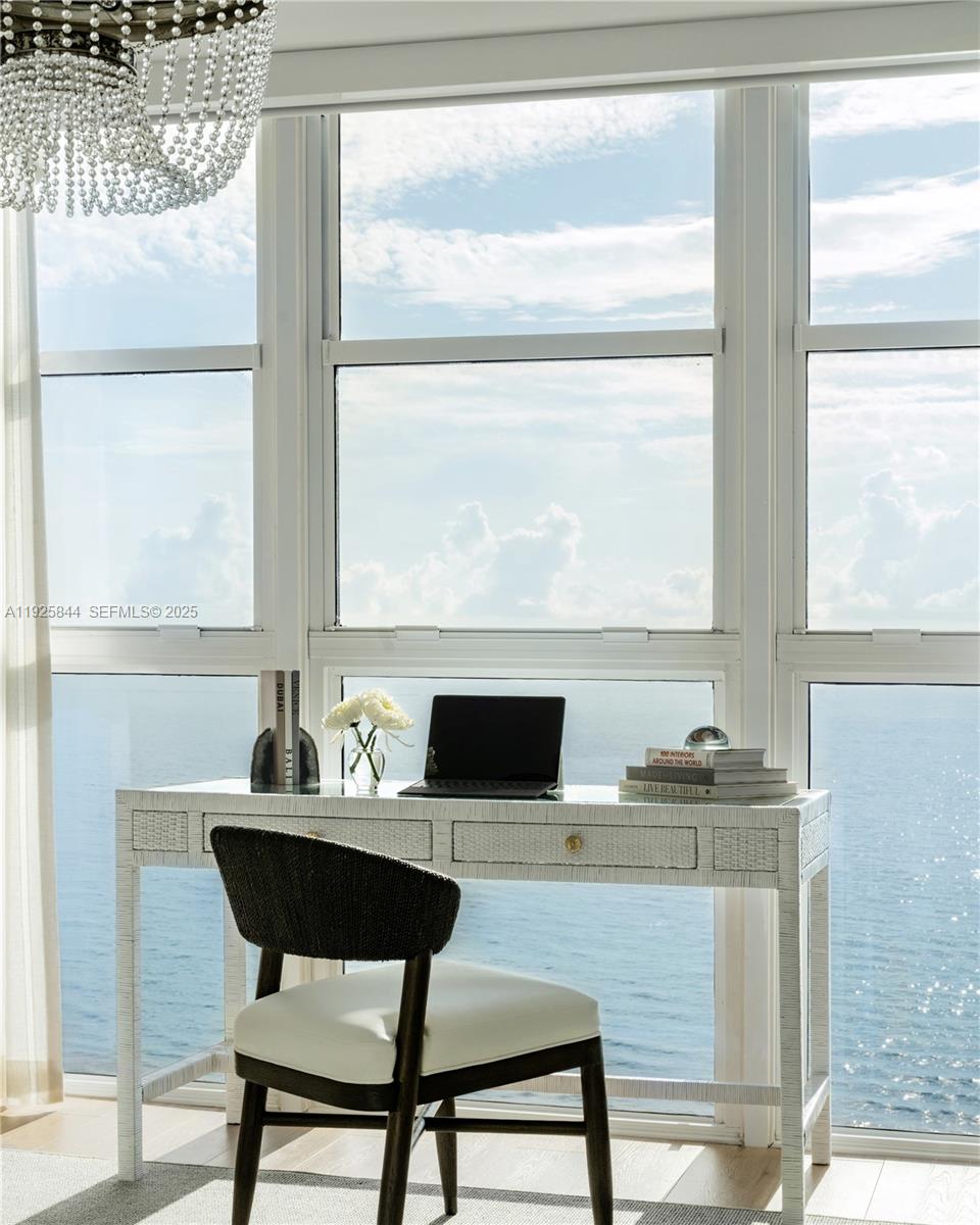 5757 Collins Avenue, Unit 1706 Miami Beach, FL 33140 - Photo 17 of 20 a kitchen with a table and chairs in it